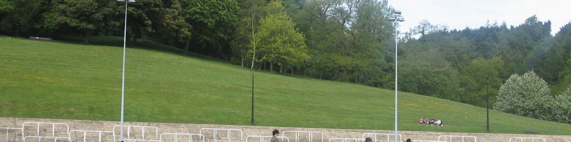 Rugby Ground and Hillside The rugby ground and a wooded hillside in Pontypool Ppark, seen with a horse show taking place. Keywords: sports ground, hill, trees