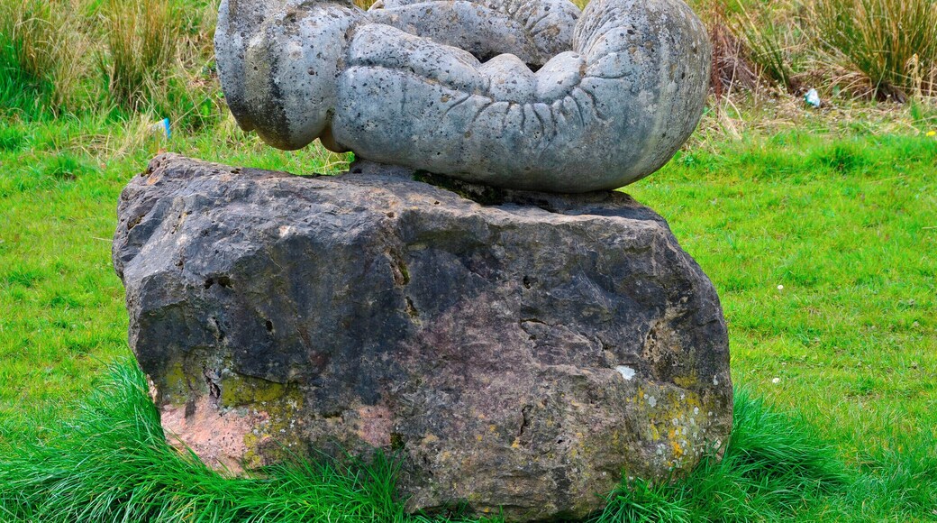 Sculptor Robert Kennedy.
Six separate small upright works set on stone bases; two boxing gloves, two dolls, cherub and a skull. Information from Festival Park: 'The works were carved away from site during 1991. They are made to operate as conventional garden ornamentation, within a constructed garden. The boxing gloves are there to depict some of their associated aspects, such as maleness and competition. The dolls depict something of how an image is idealised for mass consumption, becoming a distortion of the human figure. Both the gloves and the dolls can be seen as gendering devices through role play. The cherub and skull are life and death charms. Each of these suggests ways in which we adopt roles in society. What we really are is never as clear cut as what these images suggest.'
Borderline was supported by Garden Festival Wales and Chapter Arts Centre. 'The sculptor, Robert Kennedy, felt that the Garden Festival was a huge, themed social event in itself. He wanted to create a themed garden within it, something social, commenting to some extent on the diversity of culture within real society.'
A number of sculptures were commissioned for the Garden Festival of Wales in 1991/2 and some works remain on site.