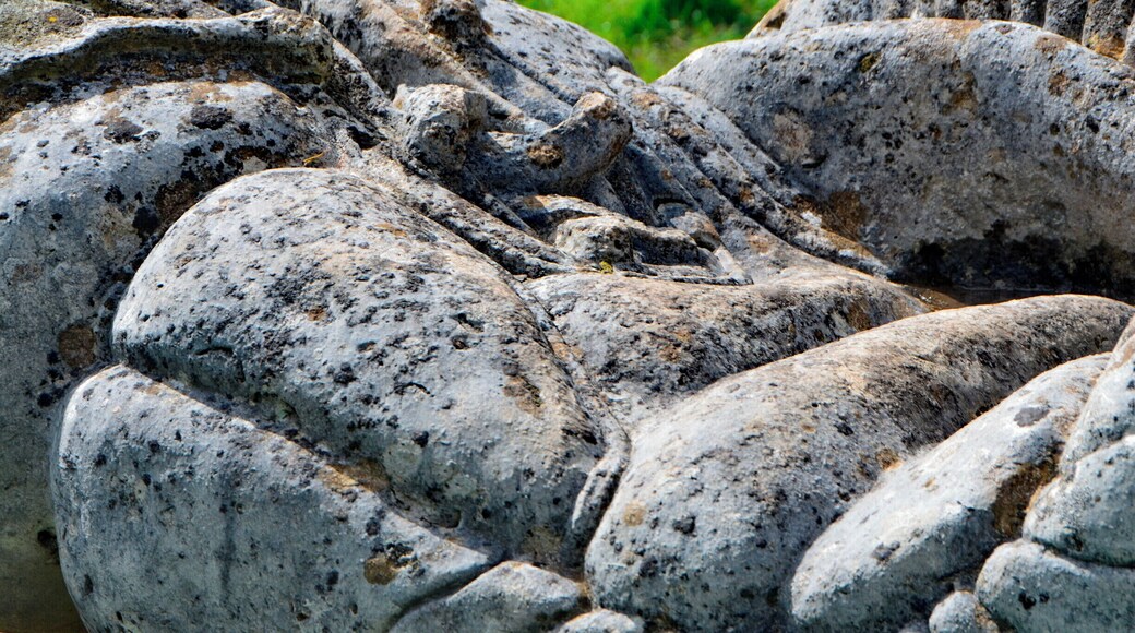 Sculptor Robert Kennedy.
Six separate small upright works set on stone bases; two boxing gloves, two dolls, cherub and a skull. Information from Festival Park: 'The works were carved away from site during 1991. They are made to operate as conventional garden ornamentation, within a constructed garden. The boxing gloves are there to depict some of their associated aspects, such as maleness and competition. The dolls depict something of how an image is idealised for mass consumption, becoming a distortion of the human figure. Both the gloves and the dolls can be seen as gendering devices through role play. The cherub and skull are life and death charms. Each of these suggests ways in which we adopt roles in society. What we really are is never as clear cut as what these images suggest.'
Borderline was supported by Garden Festival Wales and Chapter Arts Centre. 'The sculptor, Robert Kennedy, felt that the Garden Festival was a huge, themed social event in itself. He wanted to create a themed garden within it, something social, commenting to some extent on the diversity of culture within real society.'
A number of sculptures were commissioned for the Garden Festival of Wales in 1991/2 and some works remain on site.
