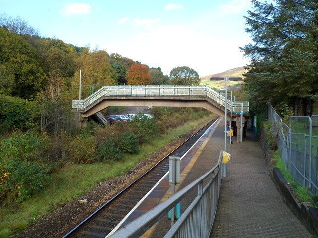 Llwynypia railway station. Viewed down the access ramp from the A4058. Llwynypia station is on the Rhondda Line, between Tonypandy station to the south and Ystrad Rhondda station to the north. The footbridge leads to the station's car park (capacity 12 vehicles).