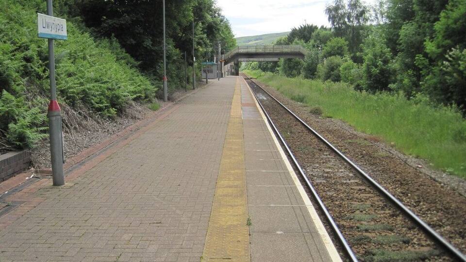 Llwynypia railway station, Rhondda Cynon Taf. Opened in 1863 by the Taff Vale Railway on the line from Cardiff to Treherbert. View south towards Tonypandy and Cardiff. The remains of the former northbound platform are hidden in the undergrowth to the right.