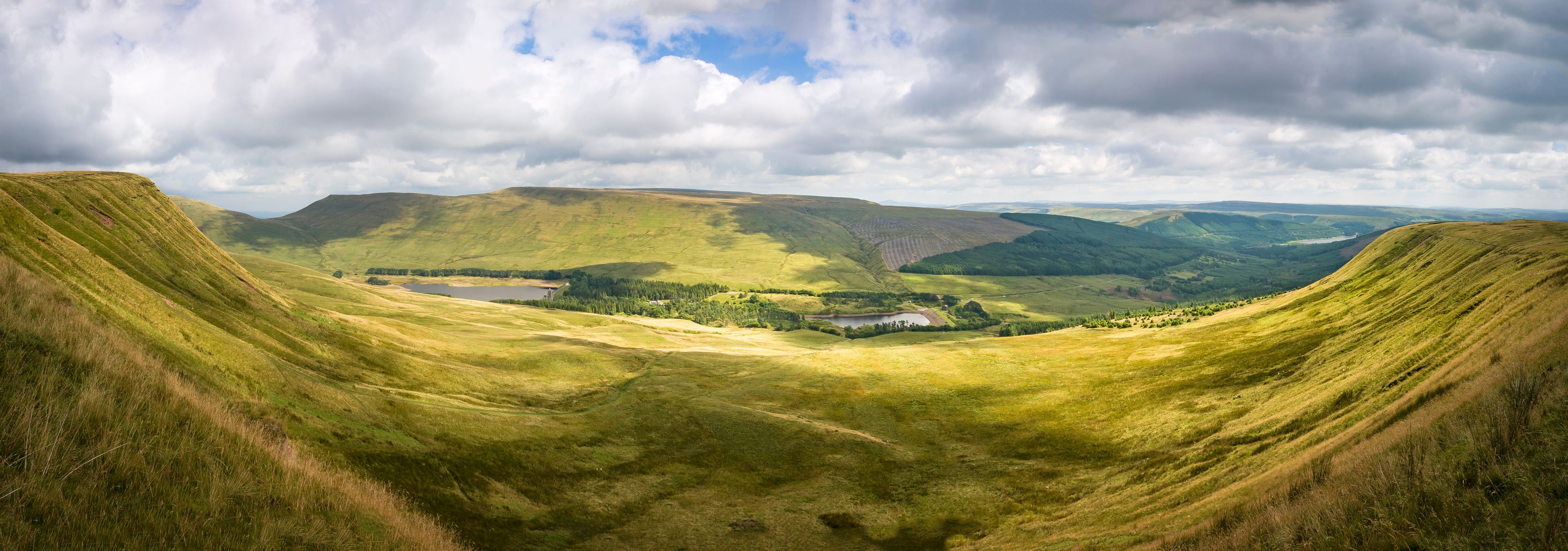 A valley with rolling hills, a lake, and a small settlement.