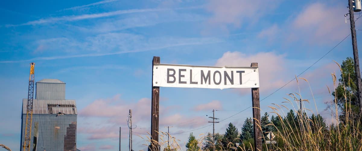 A sign reading "BELMONT" with a construction crane and power lines in the background.