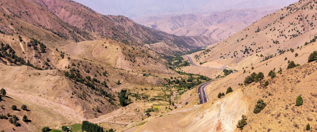 Kamchik Pass viewpoint overlooking Qurama Mountains - Uzkbekistan. The pass provides a strategically important route as an access Tashkent and the Fergana Valley.