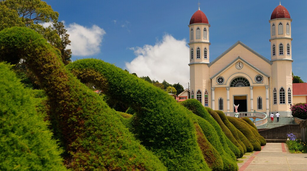 Topiary garden bushes and path in Zarcero Costa Rica leading to stairs and church