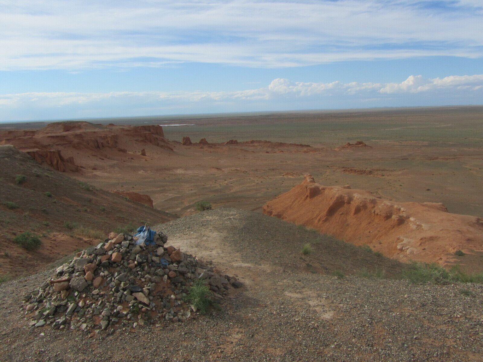 You'll see ovoo everywhere, particularly where the landscape is something to admire. The blue silk is for the blue skies. Roy Chapman Andrews found dinosaur eggs and bones in this area of Bayanzag in the Gobi. #Gobi Desert