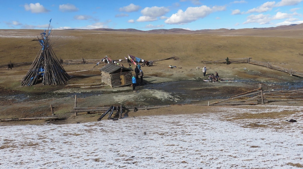 I love this photo because it captures a few things quintessential to the Mongolian landscape. On the left is a Shamanic teepee for honoring the elements and making wishes for good fortune. On the right you see herders washing their clothes in hot springs. There are 63 (or there abouts) hot springs across the country. The wide steppes go on forever beyond the dusting of early snow. And then there's a sky - a beautiful element for sure!