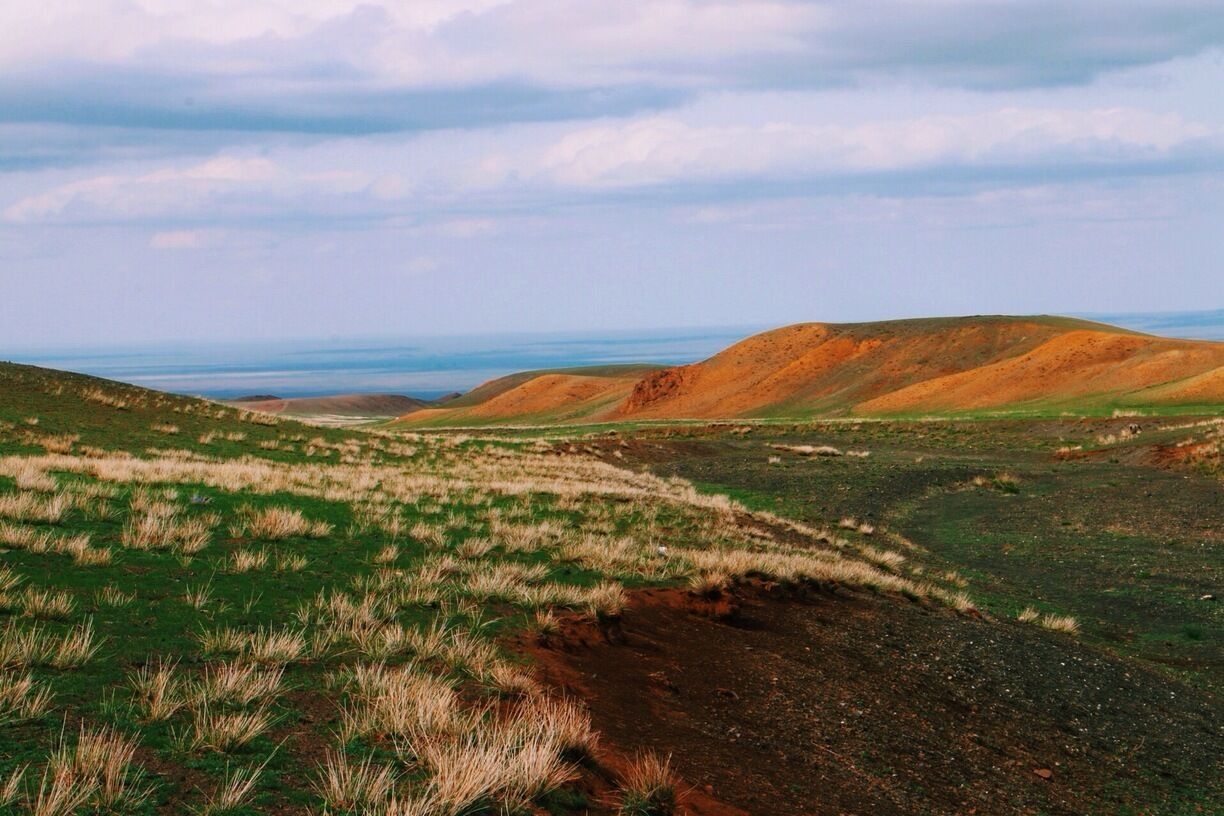 Just near Yolin Am, Mongolia. I love the red soil of the hillsides in this area.   #troverdetour