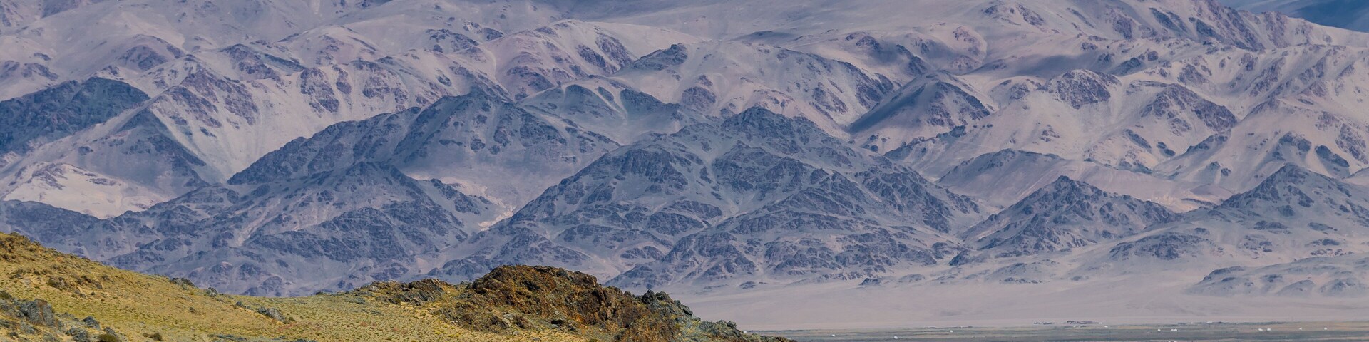 Desert landscape. Mountains on the background. Road through the steppe. Mongolian yurt in steppe and mountains on the background. Bayan-Ölgii Province, Mongolia