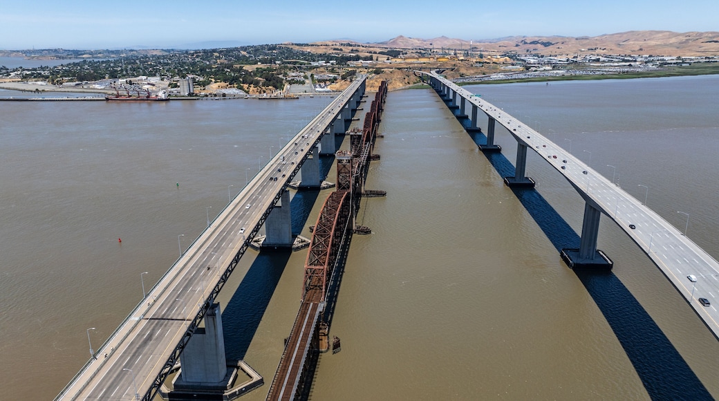 aerial landscape view of area around Carquinez Strait with three parallel Benicia-Martinez Railroad Bridge and Benicia–Martinez Bridge (Interstate 680), traffic running in both directions