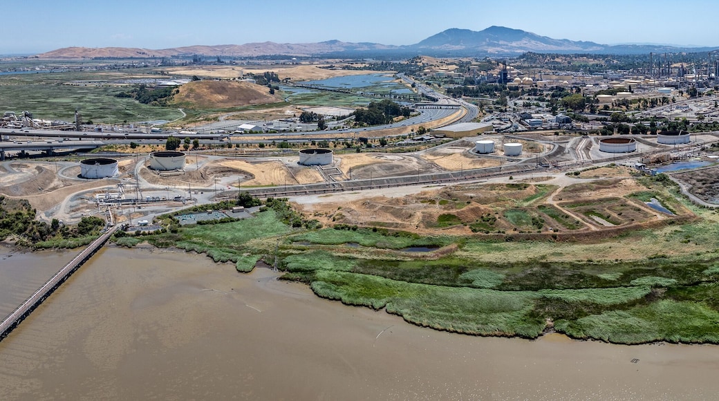 panoramic aerial view of shoreline at Carquinez Strait, from Benicia–Martinez Bridge (Interstate 680) across industrial area of Martinez, located in Contra Costa County, California