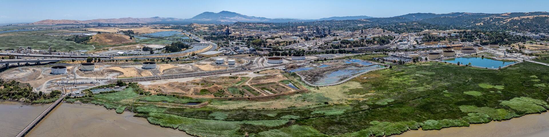 panoramic aerial view of shoreline at Carquinez Strait, from Benicia–Martinez Bridge (Interstate 680) across industrial area of Martinez, located in Contra Costa County, California