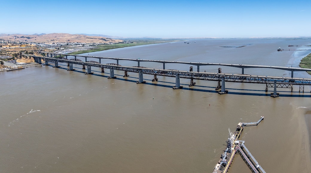 panoramic aerial landscape view of area around Carquinez Strait with Benicia-Martinez Railroad Bridge and Benicia–Martinez Bridge (680) with traffic running in both directions