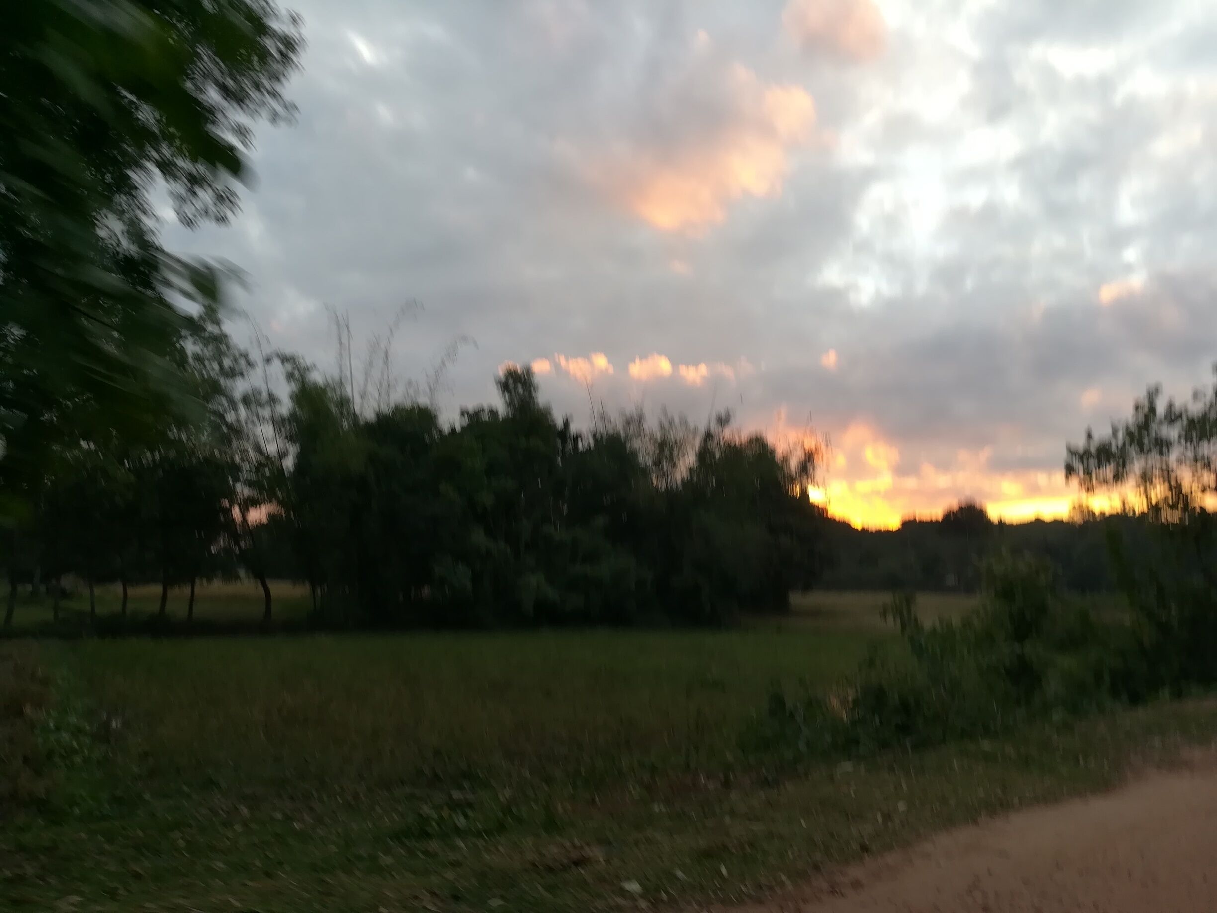 Sun sets fire on sky during sunset.