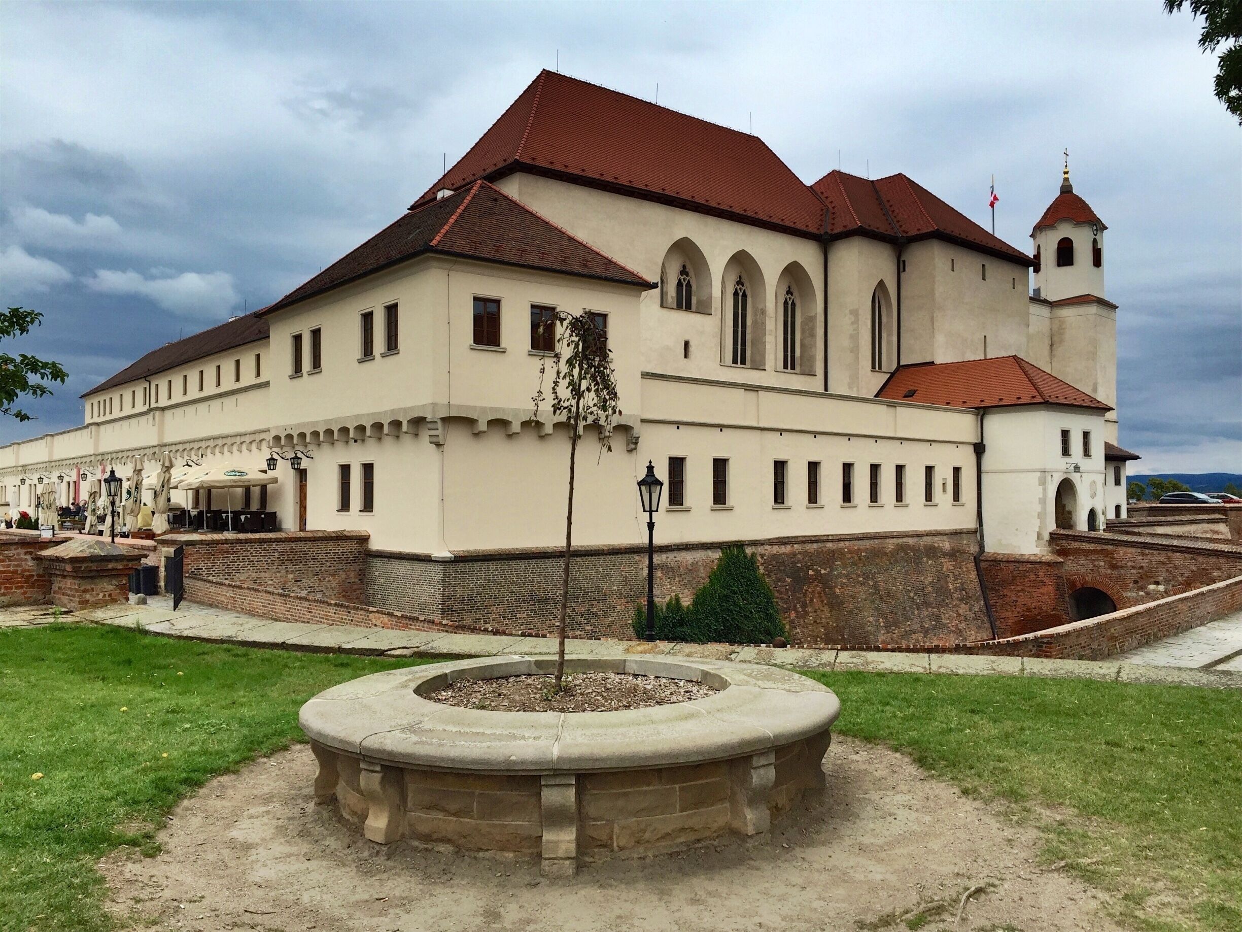 Špilberk Castle is a castle on the hilltop in Brno, Southern Moravia. Its construction began as early as the first half of the 13th century by the Přemyslid kings and complete by King Ottokar II of Bohemia.  From a major royal castle established around the mid-13th century, and the seat of the Moravian margraves in the mid-14th century, it was gradually turned into a huge baroque fortress considered the harshest prison in the Austro-Hungarian empire, and then into barracks. This prison had always been part of the Špilberk fortress.