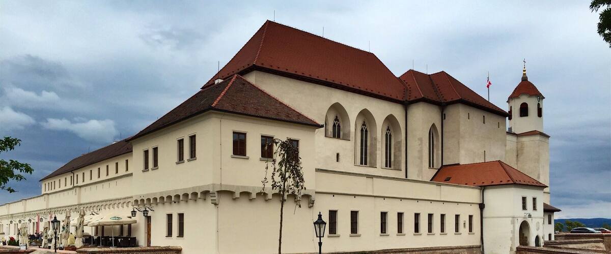 Špilberk Castle is a castle on the hilltop in Brno, Southern Moravia. Its construction began as early as the first half of the 13th century by the Přemyslid kings and complete by King Ottokar II of Bohemia. From a major royal castle established around the mid-13th century, and the seat of the Moravian margraves in the mid-14th century, it was gradually turned into a huge baroque fortress considered the harshest prison in the Austro-Hungarian empire, and then into barracks. This prison had always been part of the Špilberk fortress.