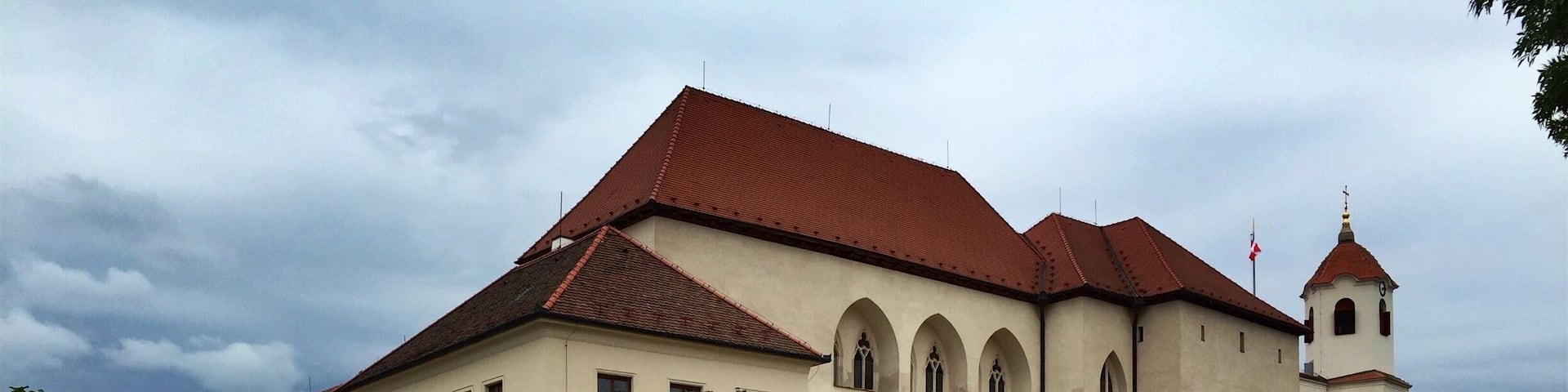 Špilberk Castle is a castle on the hilltop in Brno, Southern Moravia. Its construction began as early as the first half of the 13th century by the Přemyslid kings and complete by King Ottokar II of Bohemia. From a major royal castle established around the mid-13th century, and the seat of the Moravian margraves in the mid-14th century, it was gradually turned into a huge baroque fortress considered the harshest prison in the Austro-Hungarian empire, and then into barracks. This prison had always been part of the Špilberk fortress.