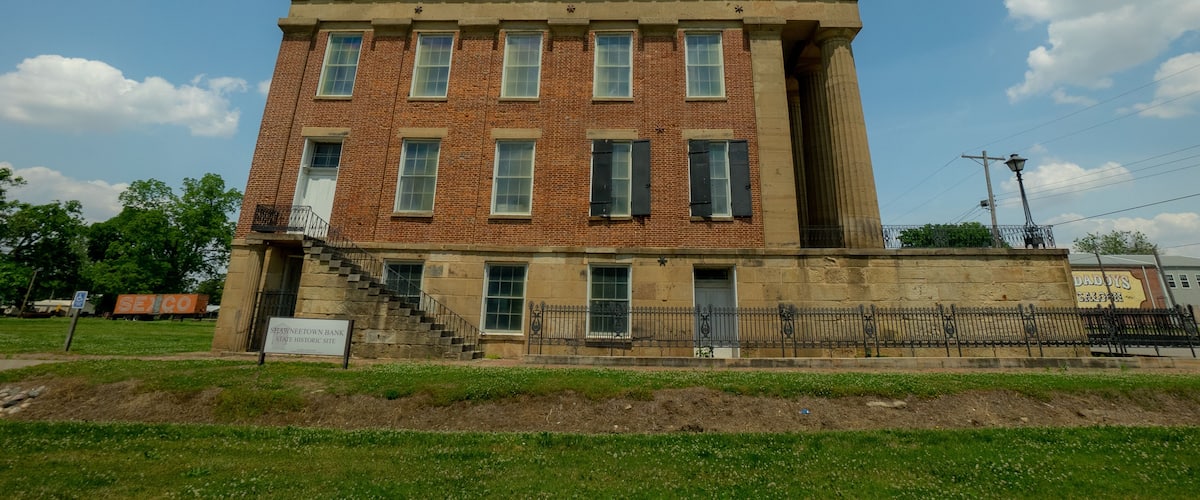 A historic Shawnee Town Bank building with a brick facade and large windows.