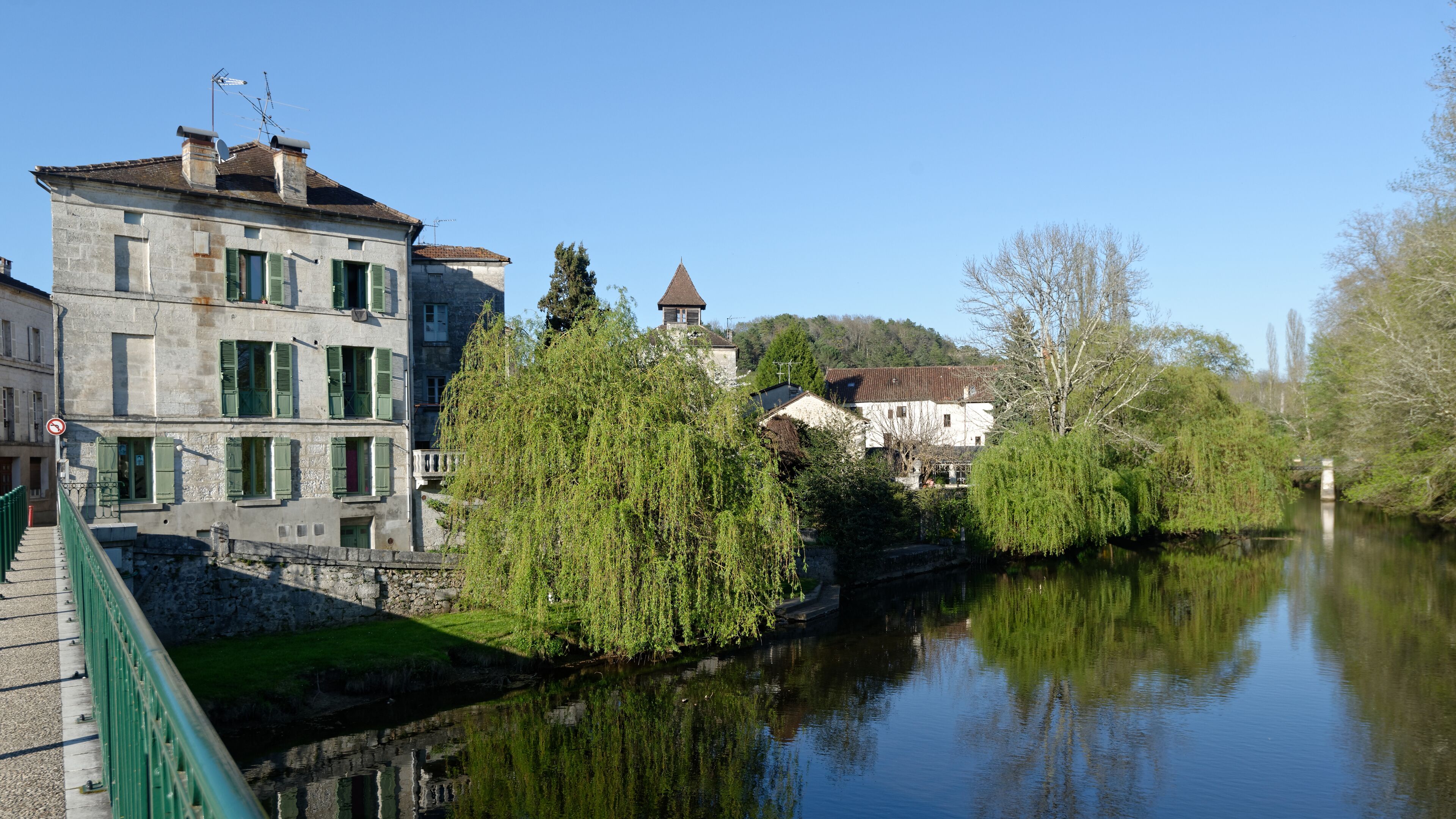 A river with buildings and trees along the banks.