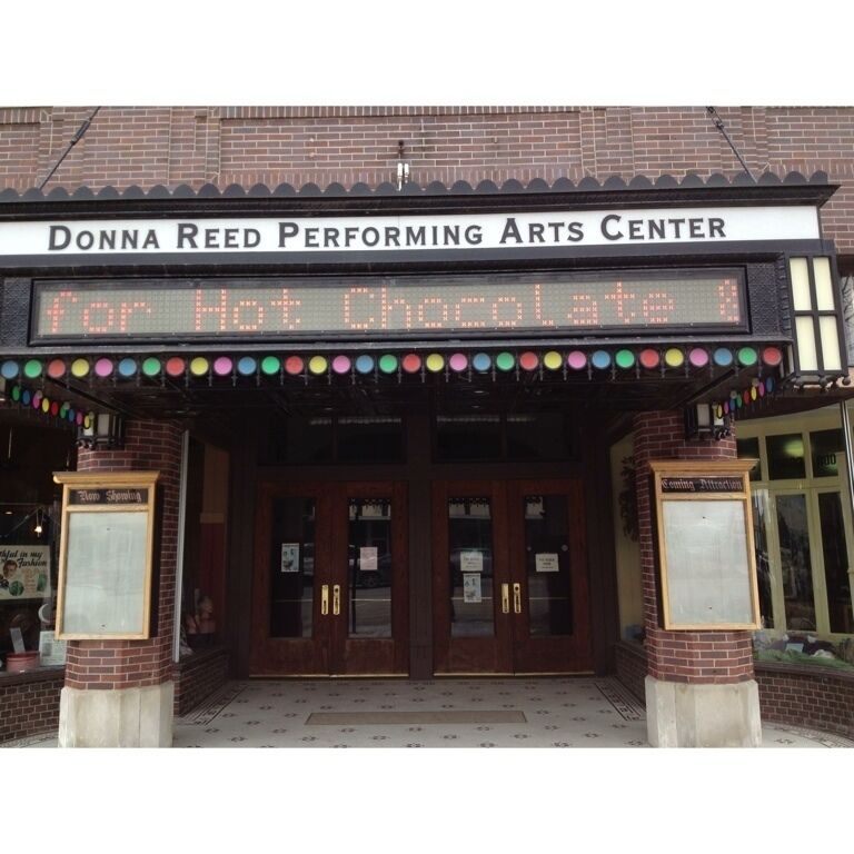 The entrance to the Donna Reed Performing Arts Center with a marquee reading "For Hot Chocolate."