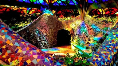 A colorful mosaic structure with a geometric roof and a central archway.