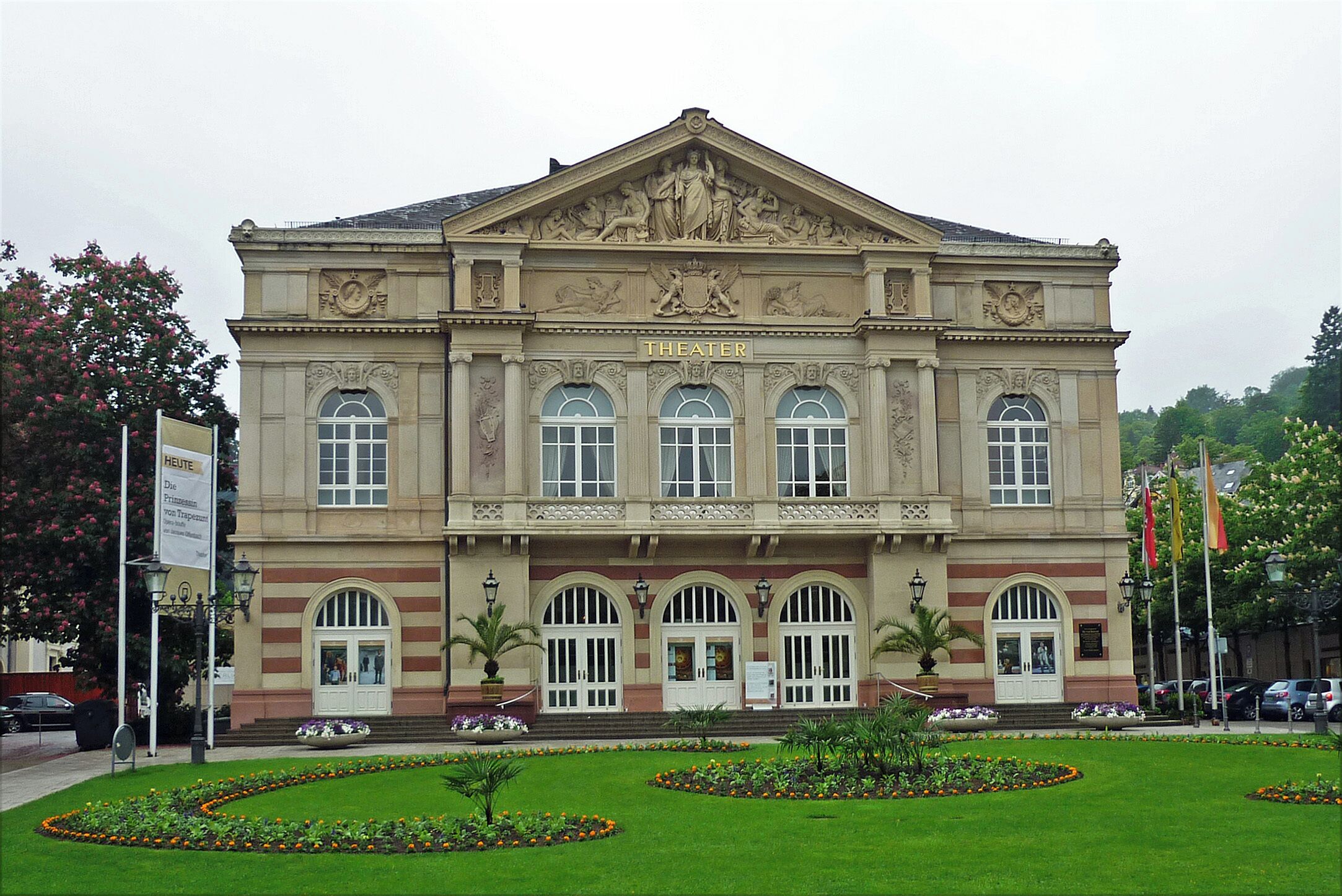 A historic theater building with classical architecture, large arched windows, and a central entrance.
