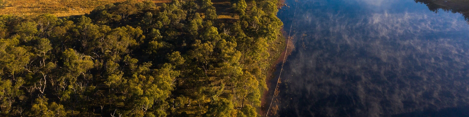 A river surrounded by dense forests and hills.