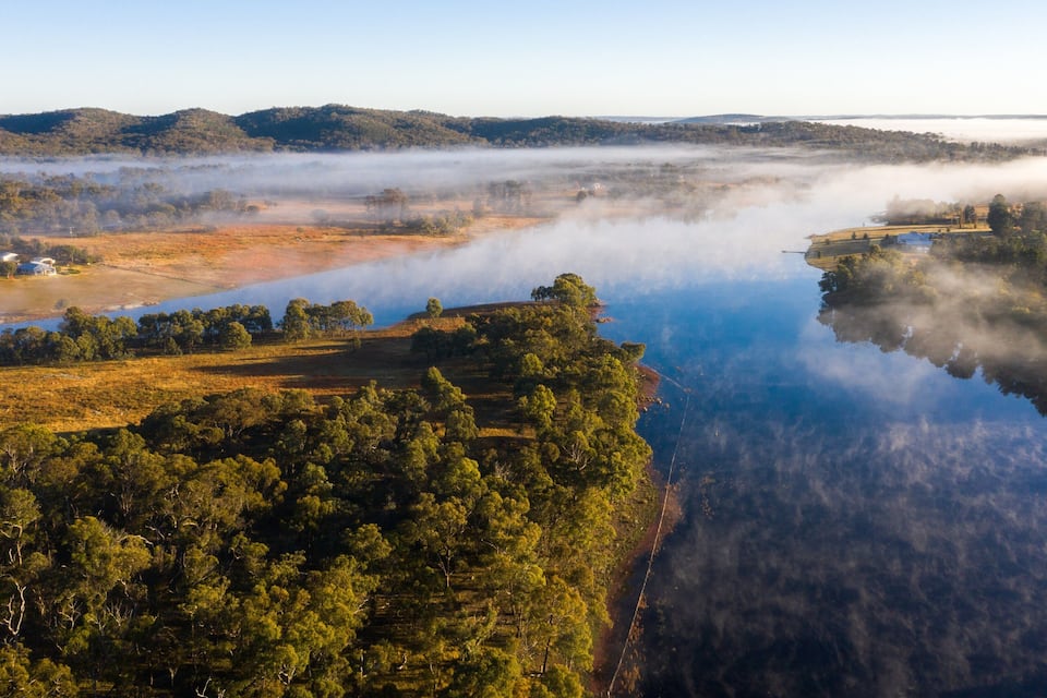 A river surrounded by dense forests and hills.