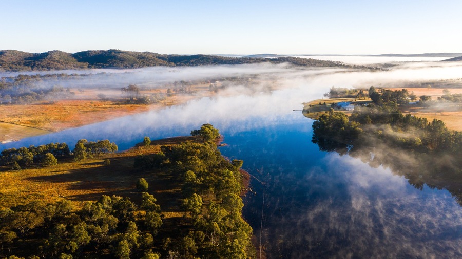 Storm King Dam showing a river or creek, a sunset and mist or fog