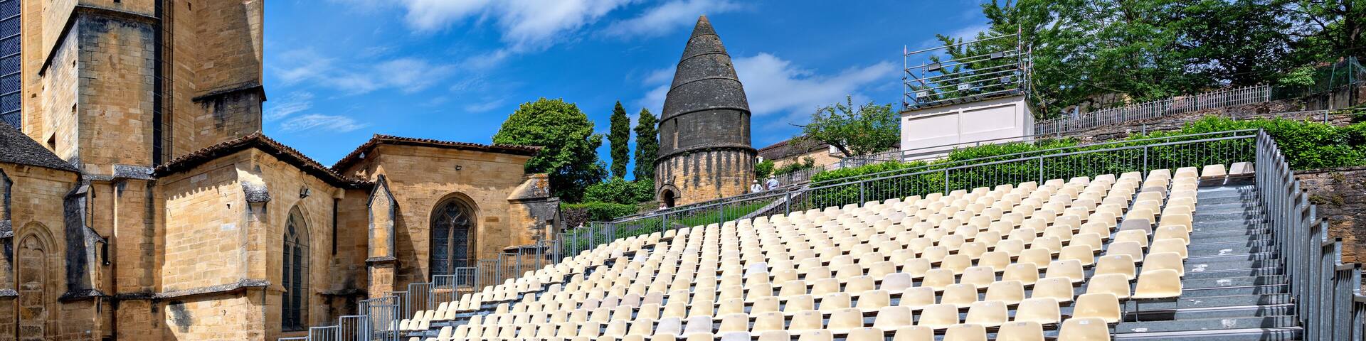 stand beside the cathedral of the Abbey of Saint-Sauveur und under the socalled lantern of the dead for the annual theatre festival in Sarlat-la-Canéda in the region Perigord, France
