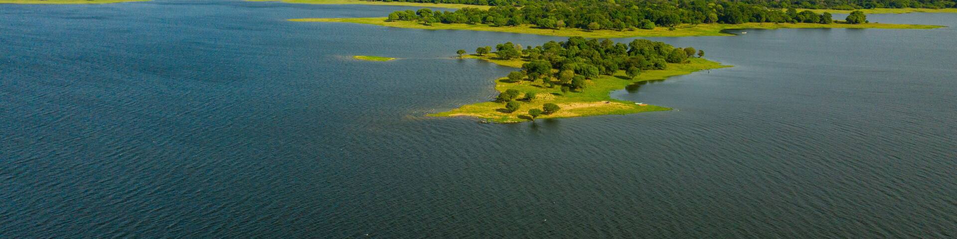 A lake with islands covered with rainforest and vegetation. Kantale tank, Sri Lanka.