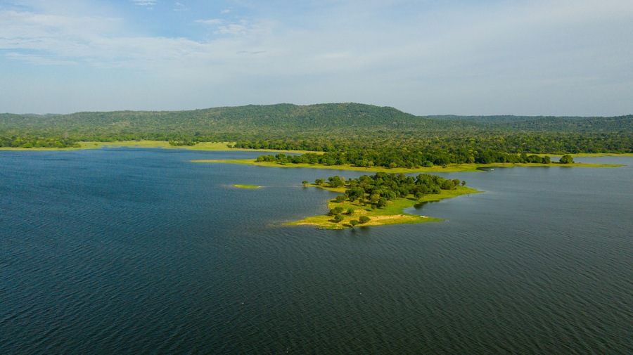 A lake with islands covered with rainforest and vegetation. Kantale tank, Sri Lanka.