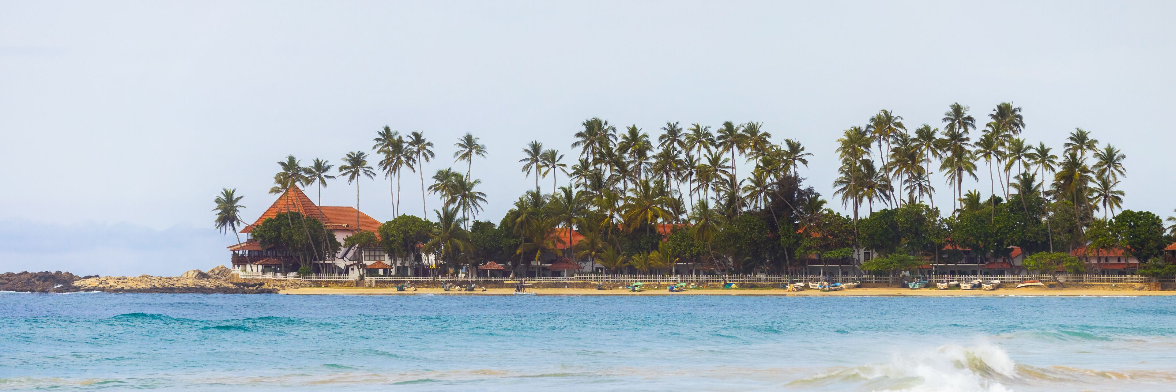 Scenic View of Dickwella Beach with Palm Trees and Resort, Sri Lanka