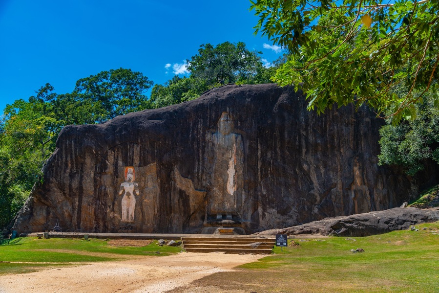 Buddha statues carved into stone at buduruwagala ancient site at Sri Lanka