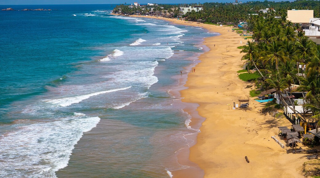 Aerial view of Hikkaduwa Beach with golden sand and turquoise waves, Sri Lanka