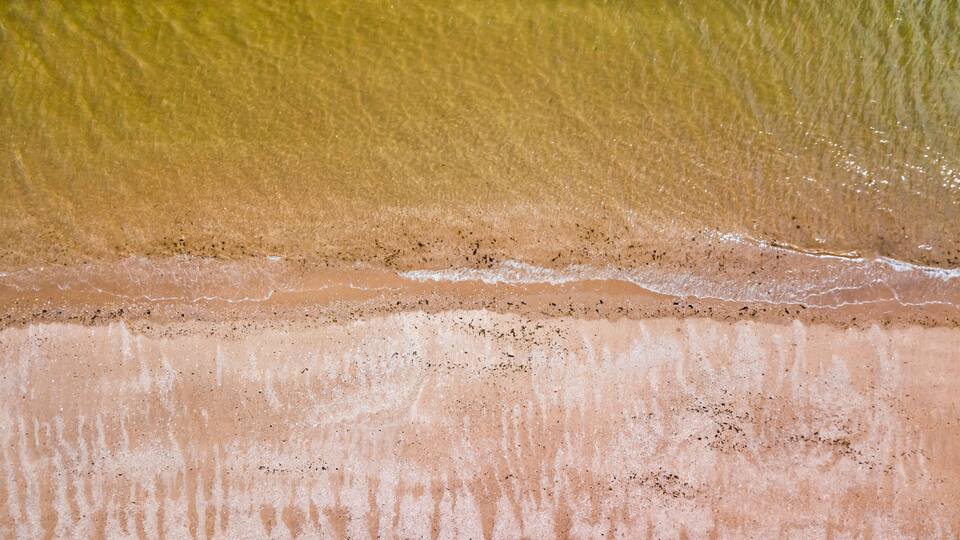 A sandy beach with gentle waves.
