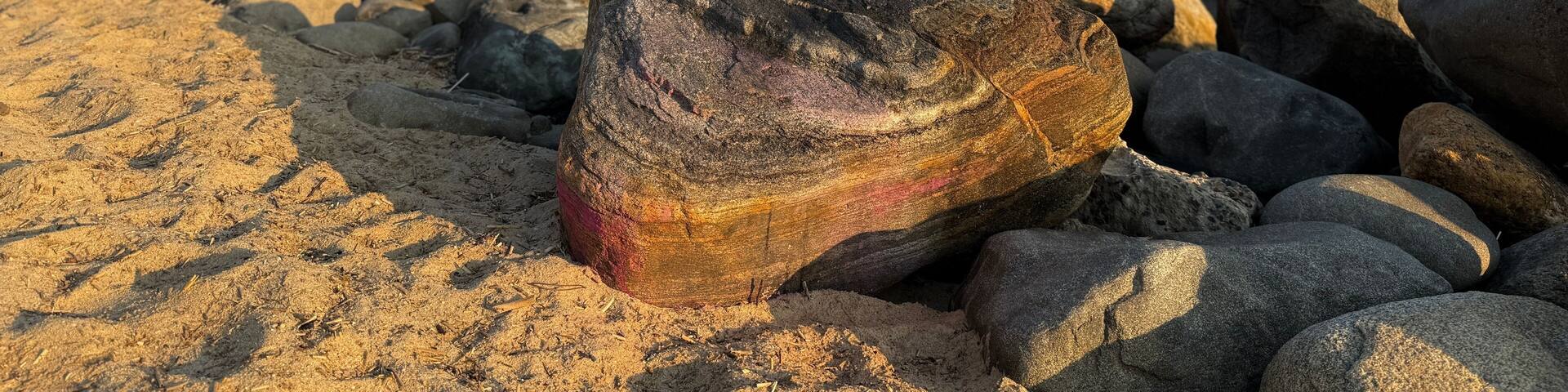 Beautiful golden hour sunrise on the beach at Kings Park Bluffs and Sunken Meadow State Park in Smithtown, NY at dawn. Hot, summer day. Clear, no clouds. Blue sky, coastline of Long Island Sound.