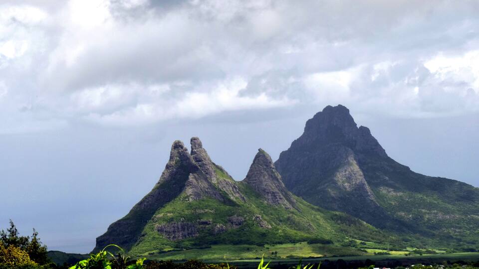 A mountainous landscape with two prominent peaks and a valley below.