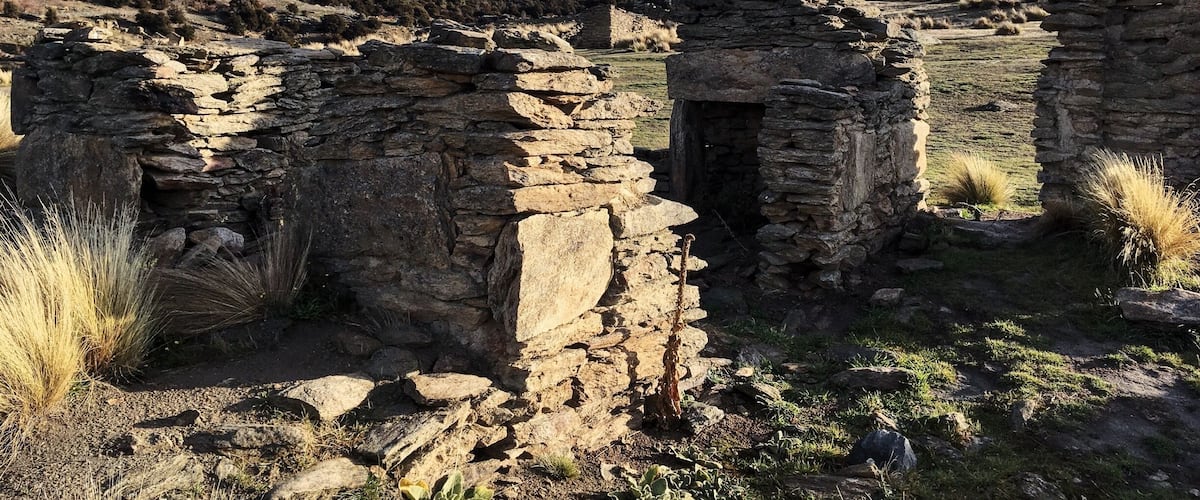 Ancient stone ruins in a hilly landscape.