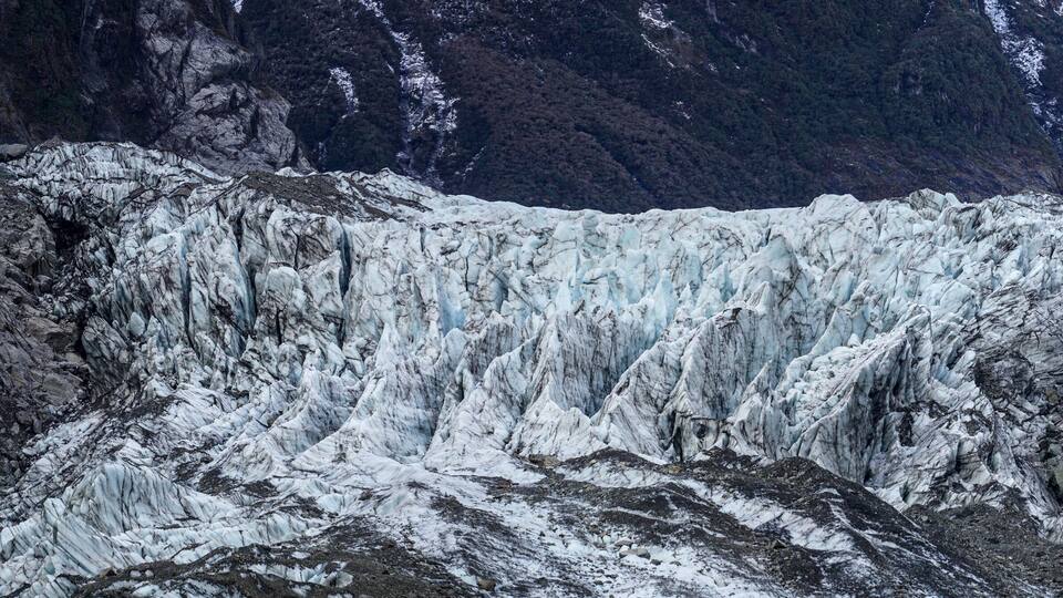 A glacier with steep, rugged cliffs and a deep crevasse.