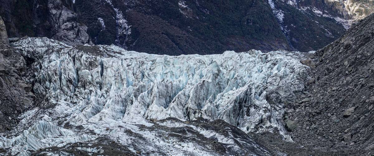A glacier with steep, rugged cliffs and a deep crevasse.