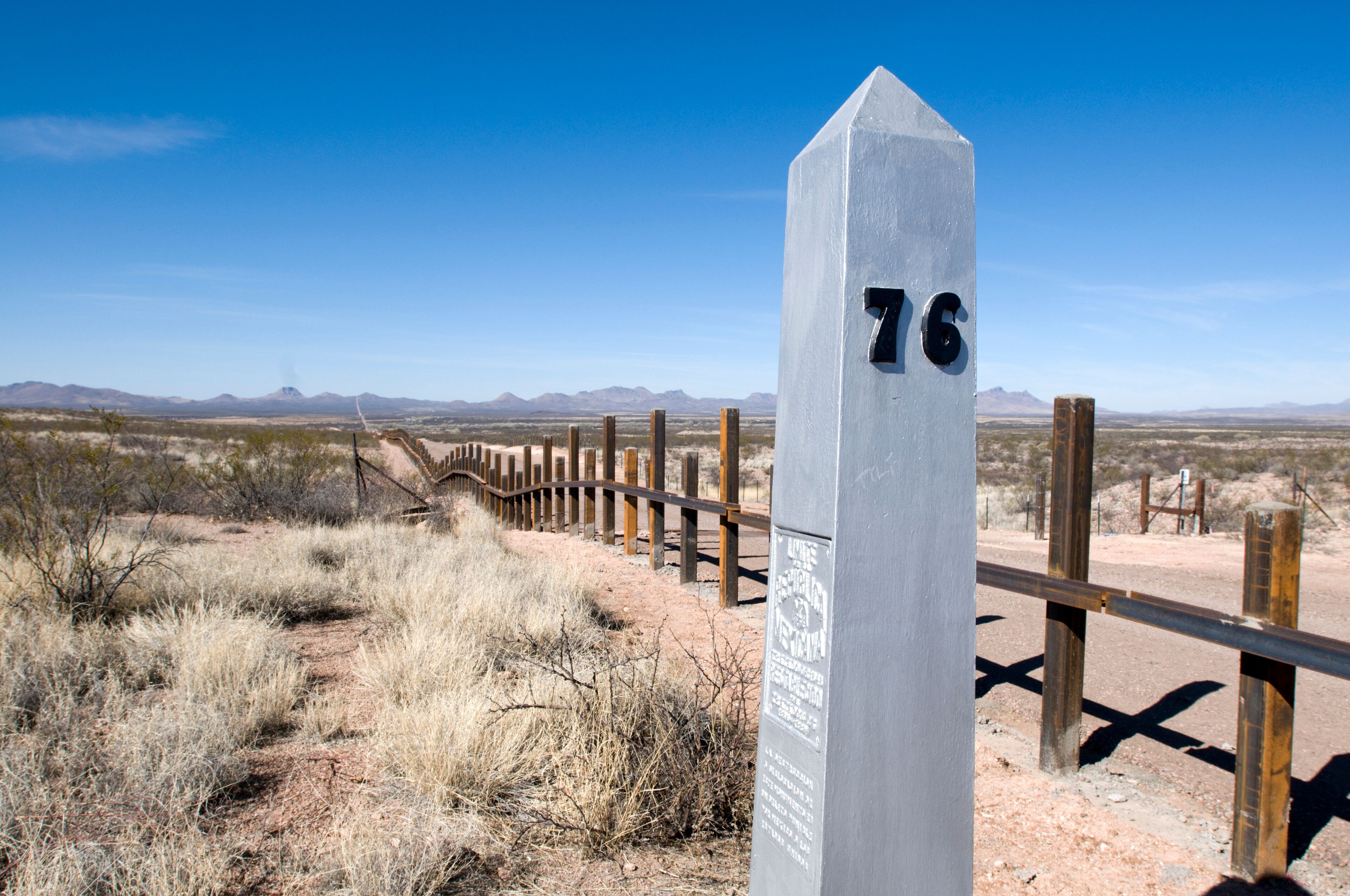 The new post & rail border fence runs next to the original border markers, Arizona.