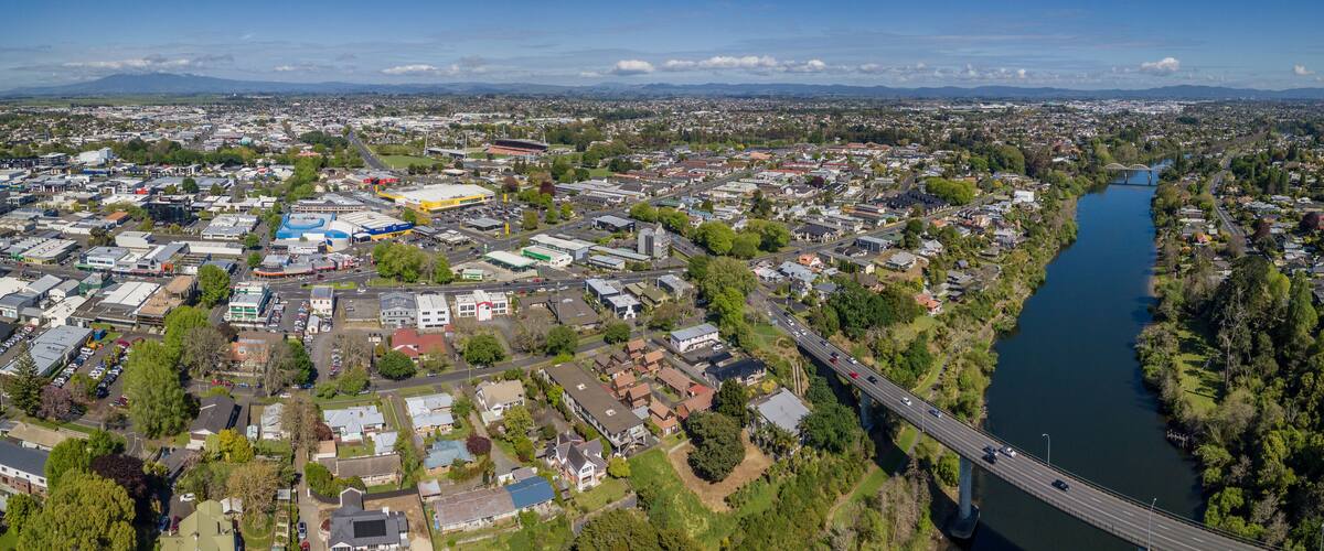 Aerial drone panoramic view looking at Whitiora Bridge over the Waikato River as it cuts through the city of Hamilton, in the Waikato region of New Zealand