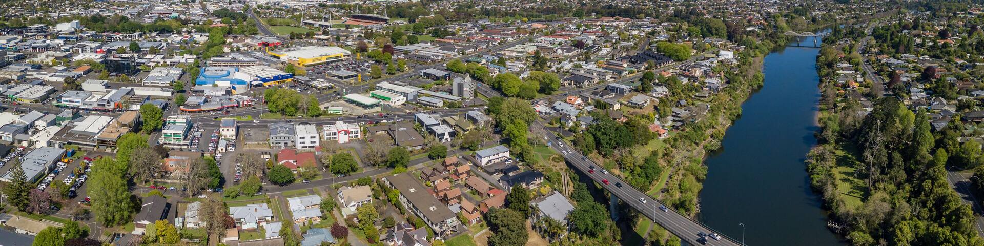 Aerial drone panoramic view looking at Whitiora Bridge over the Waikato River as it cuts through the city of Hamilton, in the Waikato region of New Zealand