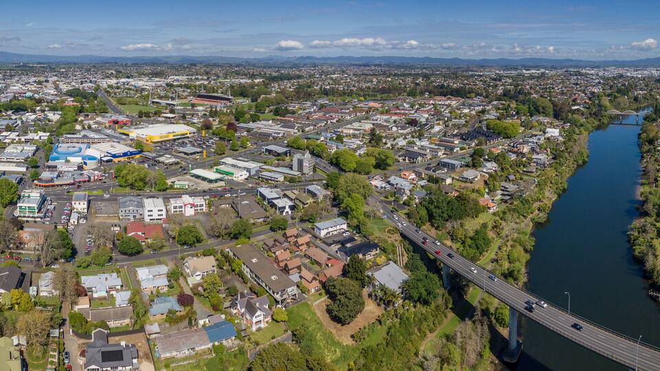 Aerial drone panoramic view looking at Whitiora Bridge over the Waikato River as it cuts through the city of Hamilton, in the Waikato region of New Zealand