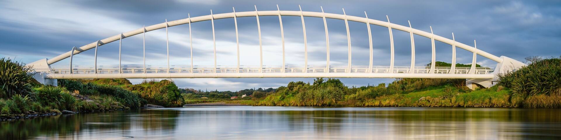 Beautiful view of the Te Rewa Rewa Bridge under a cloudy blue sky in New Plymouth, New Zealand