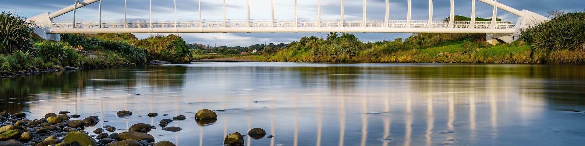 Beautiful view of the Te Rewa Rewa Bridge under a cloudy blue sky in New Plymouth, New Zealand