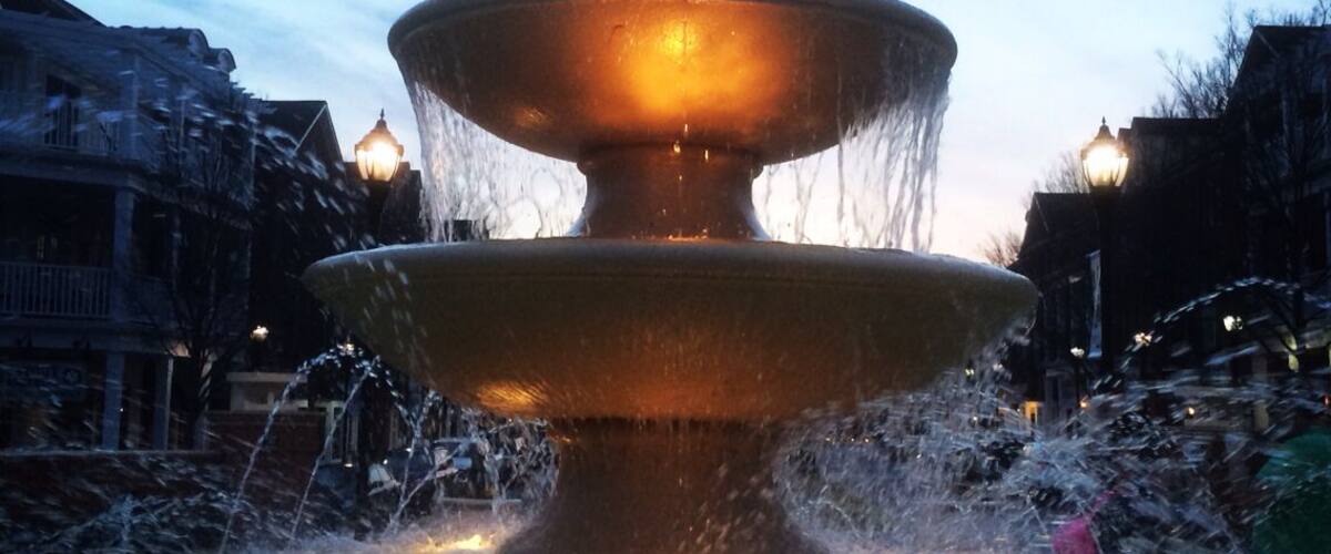 A nicely lighted fountain as day fades tonight