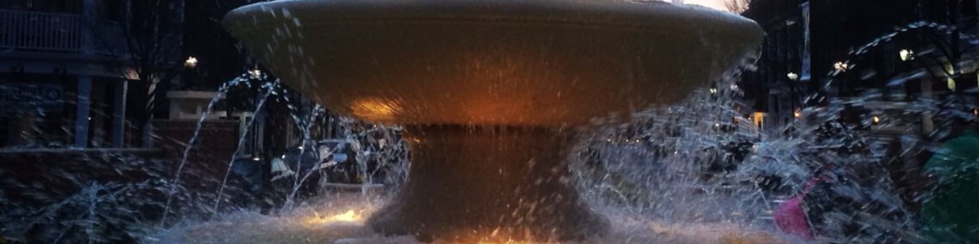 A nicely lighted fountain as day fades tonight