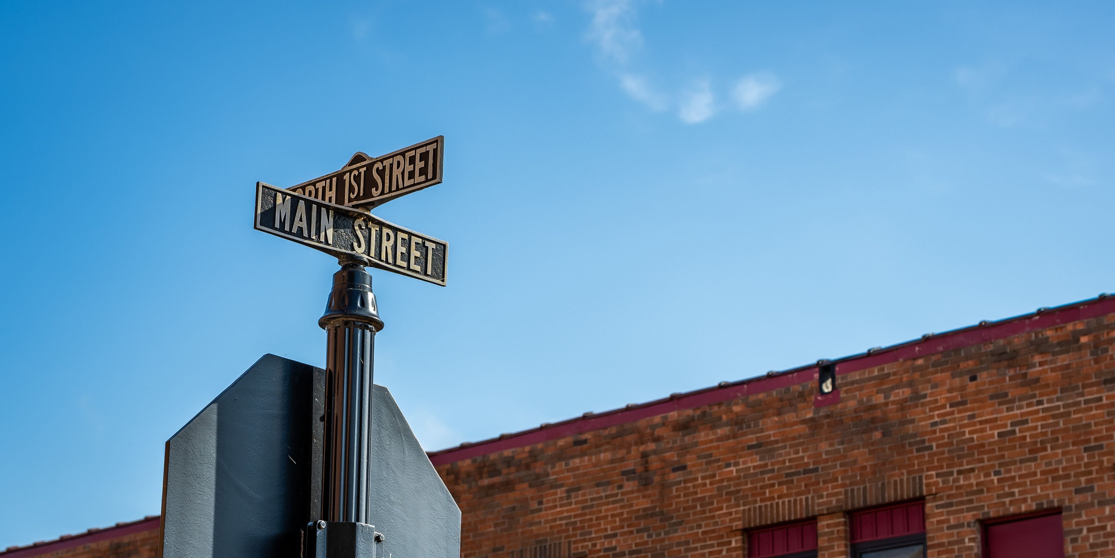 Main Street and North 1st Street sign post at downtown intersection of historical Black River Falls, Wisconsin